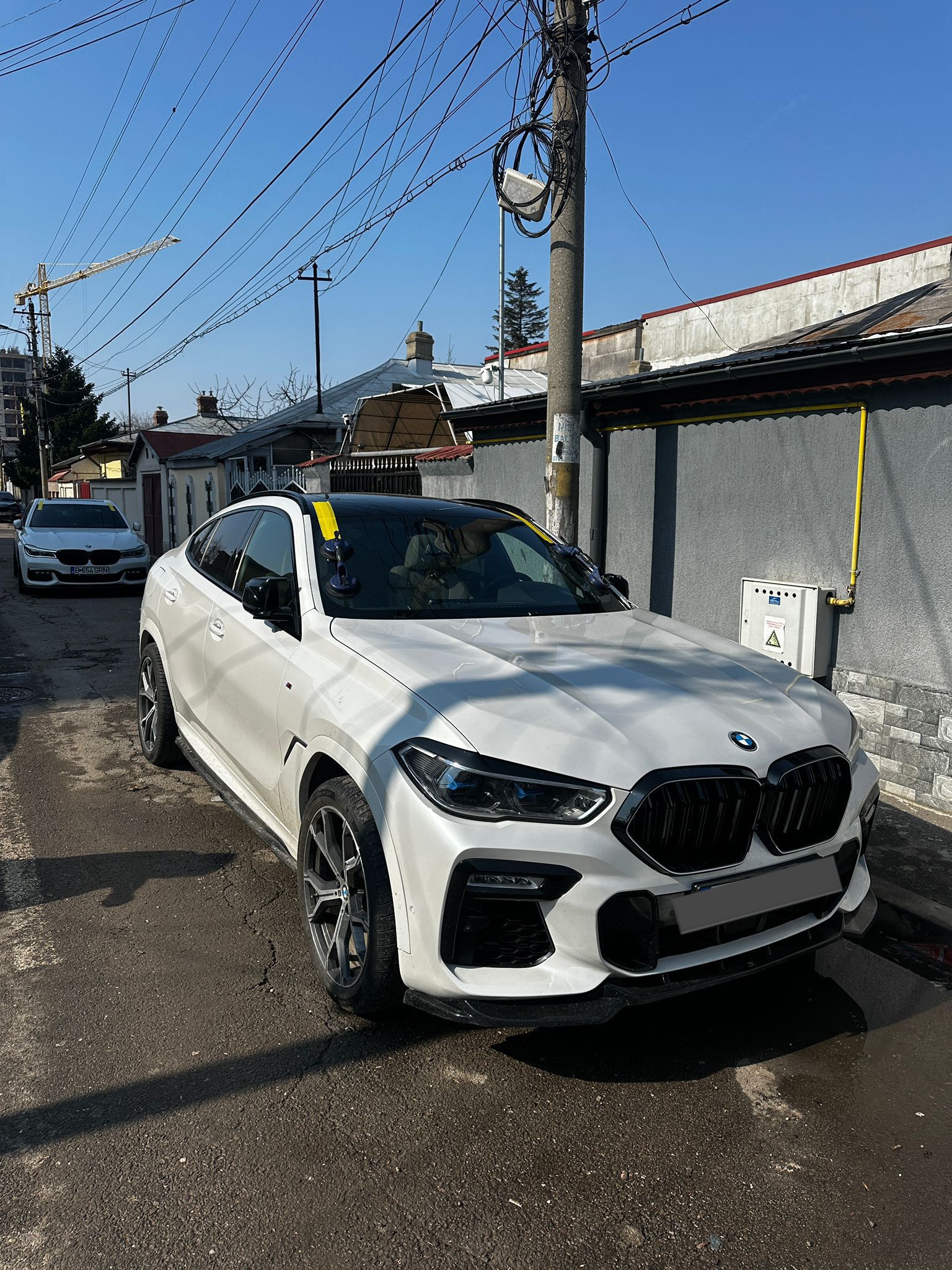 BMW X6 — windshield, residential street